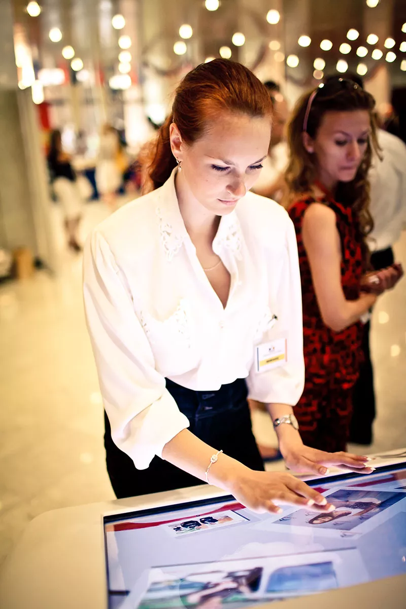 woman using infrared kiosk touch screen